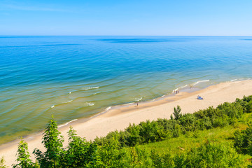 A view of sandy beach from cliff in Jastrzebia Gora coastal village, Baltic Sea, Poland - obrazy, fototapety, plakaty