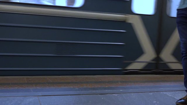 Departing Moscow metro train and passengers of mass transit system 4K video