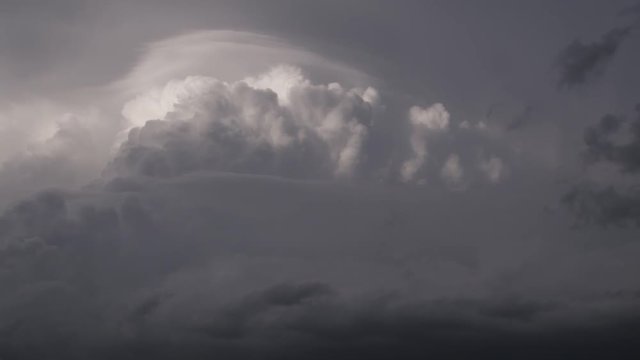 Pileus cloud draped over towering cumulus, time lapse