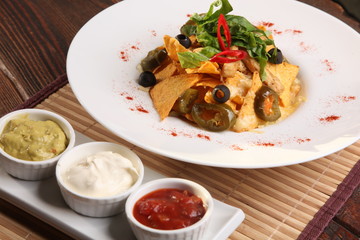 Salad with nachos and sauce guacamole