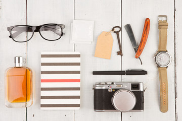 travel concept - set of cool stuff with camera and other things on wooden table