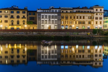 houses of florence reflecting in the arno
