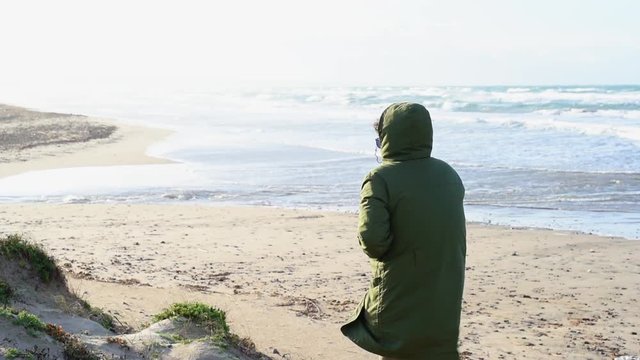 Standing on sandy beach