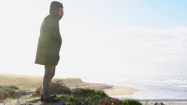 Standing on sandy beach