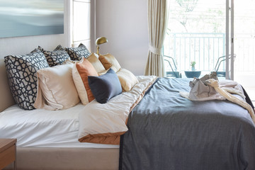 modern bedroom interior with vintage handbag on the bed