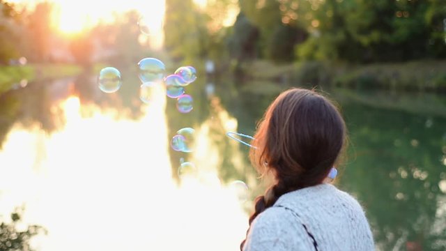 Blowing bubbles at sunset