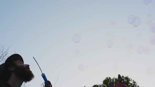 Blowing bubbles at sunset
