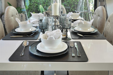 elegant table set on dining table in modern style dining room interior