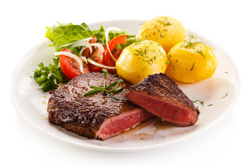 Grilled beef steaks and vegetables