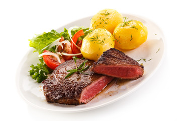 Grilled beef steaks and vegetables
