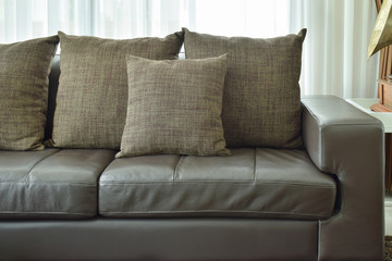 Brown texture pillows on deep brown leather sofa in the living room