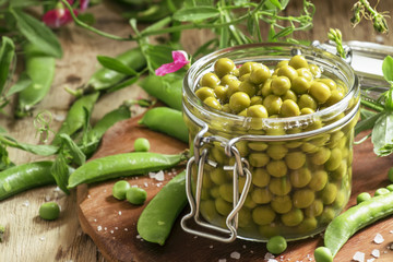 Canned sweet peas in a glass jar, fresh peas, preparation, selec