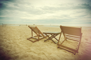 Cloudy sky on the beach and sea with relaxing table and chair fi