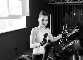 Beautiful young girl doing workout in a gym.