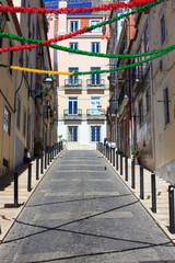 Fototapeta na wymiar Traditional street with holiday decoration in Lisbon, Portugal