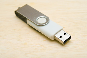 USB stick or USB thumb drive isolated on wooden board