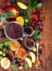 Fototapeta na wymiar Jam made from different berries in glass jars
