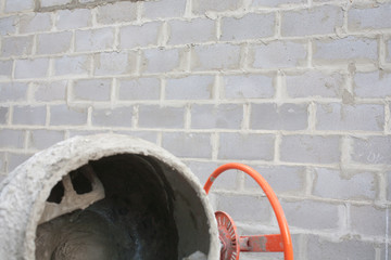 the new orange cement mixer at a construction site.