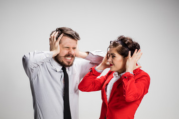 The business man and woman communicating on a gray background