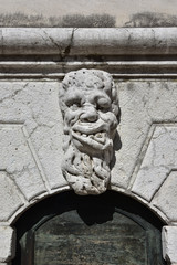 Grotesque in Venice. Bizzarre monster guardian head on Santa Formosa bell tower (17th century)