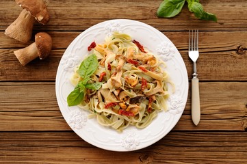 Colored pasta with wild mushrooms and basil overhead view