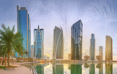 Fototapeta premium Panoramic view of Business bay and Lake Tower, reflection in a river, UAE