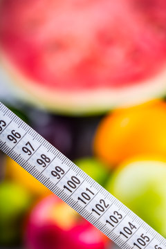 Measuring tape and Fresh vegetable and fruits in the background. Healthy diet  concept..