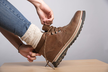 Woman's hands putting on a walking boot