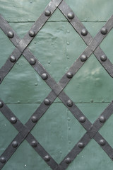 Metal stripes on a green door
