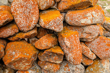 Ancient masonry with orange lichen stones