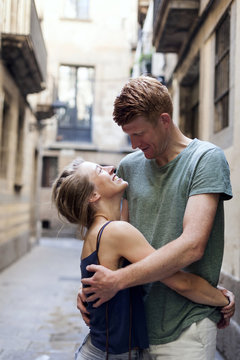 Happy couple in love embracing and looking at each other