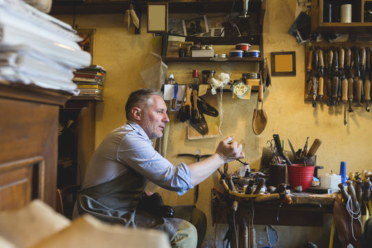 Cobbler making shoes in his workshop