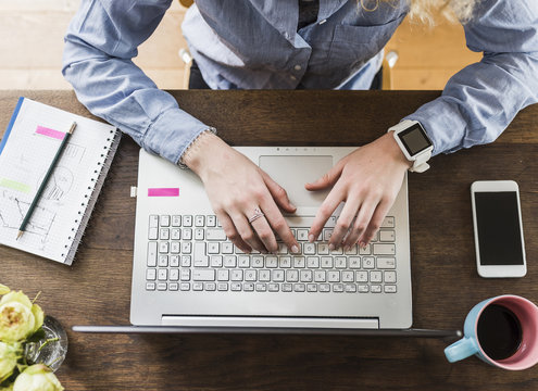 Teenage girl using laptop at desk