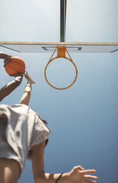 Young couple playing basketball on court