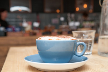 Coffee on a table in a busy cafe