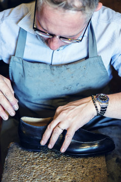 Cobbler making shoes in his workshop
