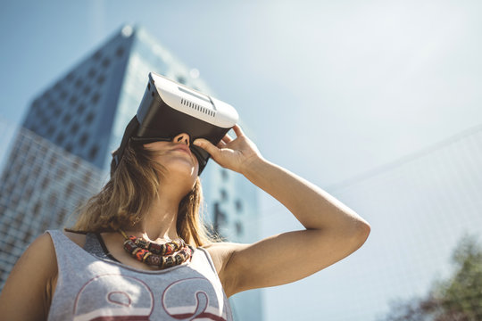 Young woman using virtual reality glasses