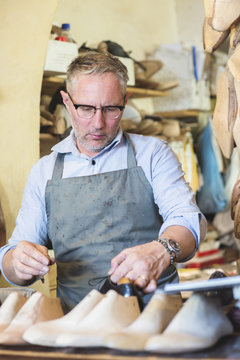 Cobbler making shoes in his workshop