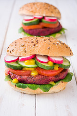 Veggie beet burger on white wooden background

