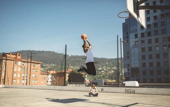 Young man aiming at basketball hoop