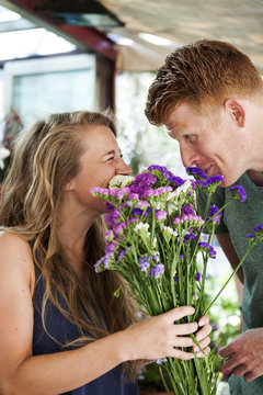 Man gifting flowers to his girlfriend