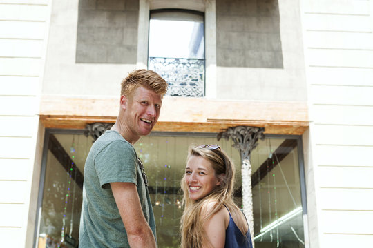 Portrait of happy couple turning around