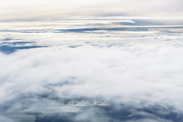 Obraz premium Aerial view from an airplane on a cloudy day.