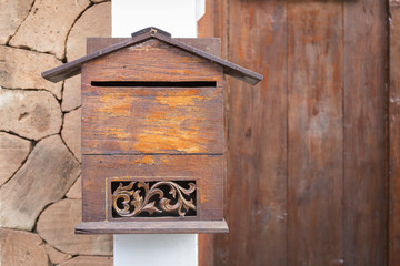 Wooden post box from Thailand with space on wooden door background