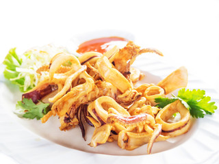 Fried squid with spicy sauce isolated on white