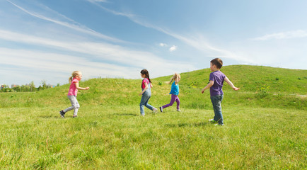 Obraz na płótnie Canvas group of happy kids running outdoors