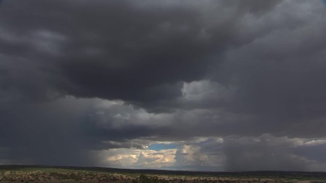 Lightning storm drifting toward desert horizon, time lapse