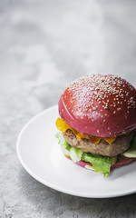 gourmet novelty chicken burger in beetroot bun