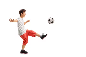 Foto auf Acrylglas Excited boy playing football © Ljupco Smokovski