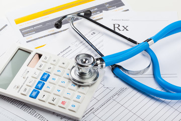 Health care costs. Stethoscope and calculator